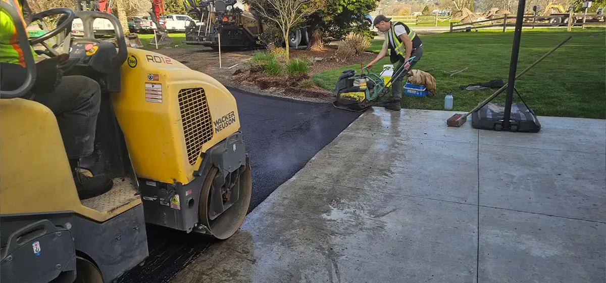 Paving crew laying asphalt on the prepared base