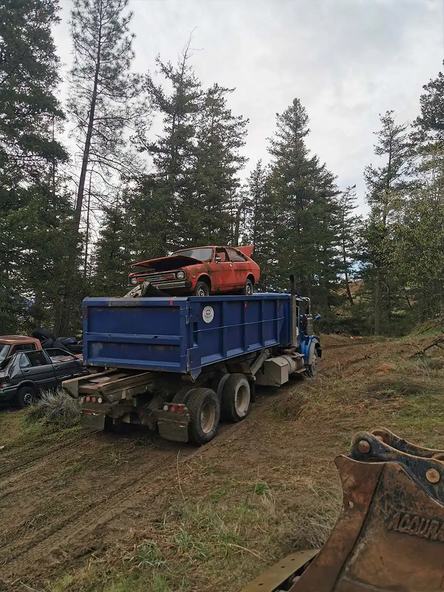Truck hauling a recovered vehicle off site