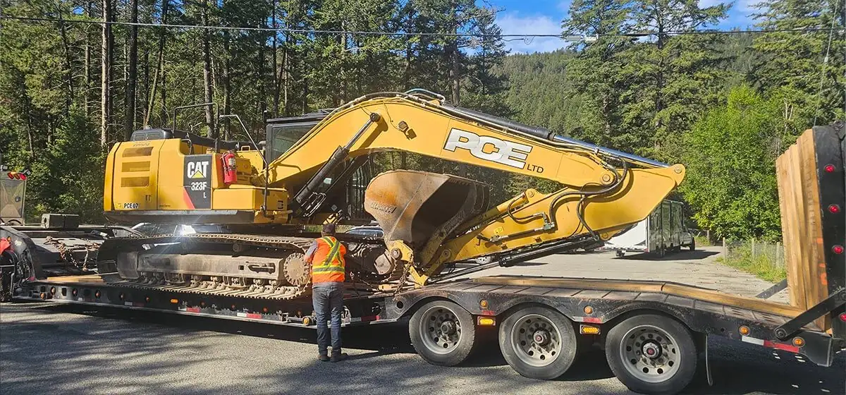 PCE excavator on a lowbed arriving at site