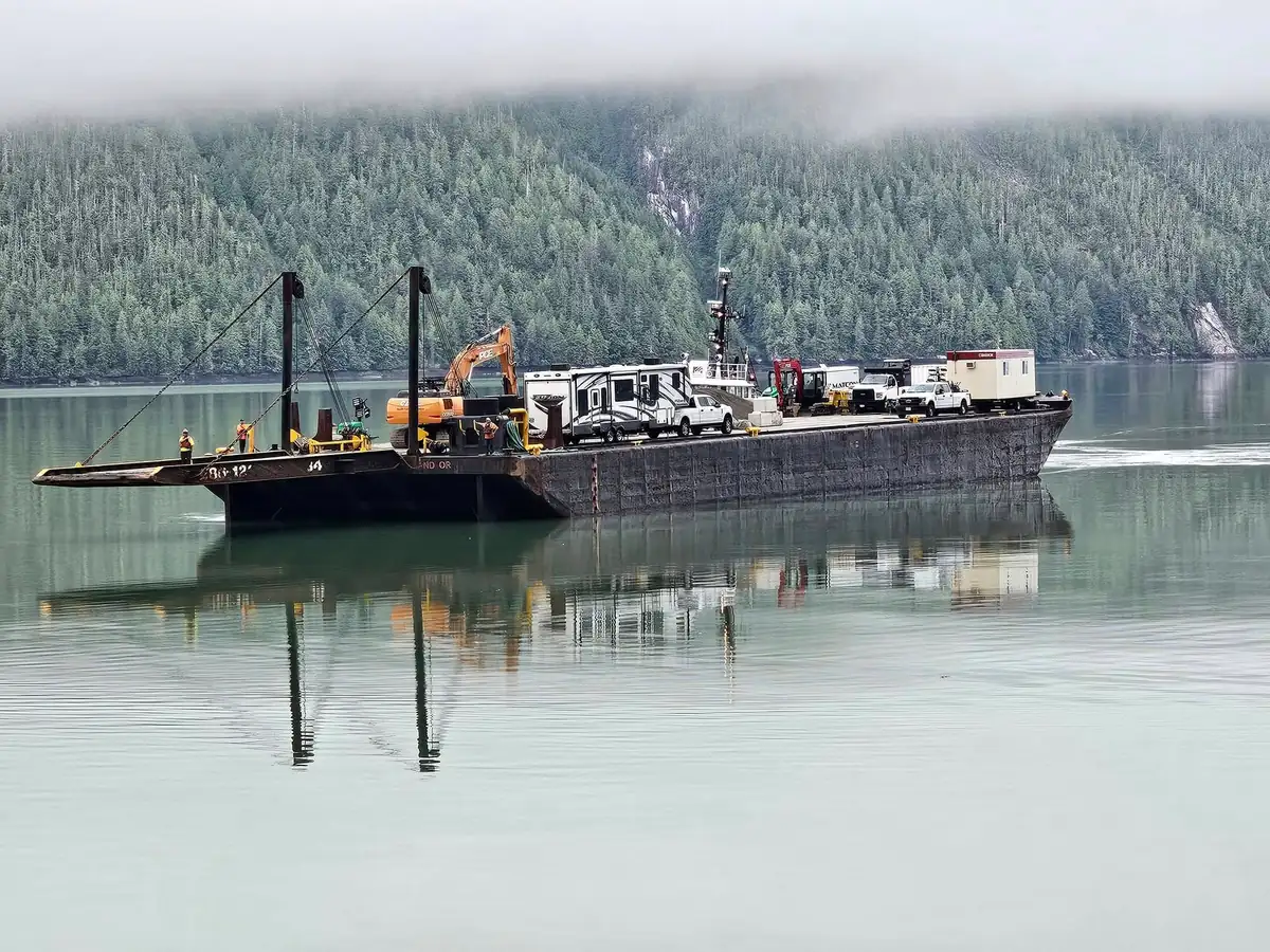 Barge with PCE excavator and crew RV crossing the inlet